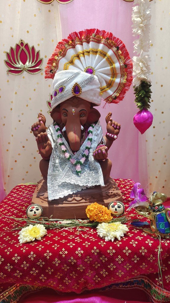 Decorated eco-friendly Ganpati murti with purple turban